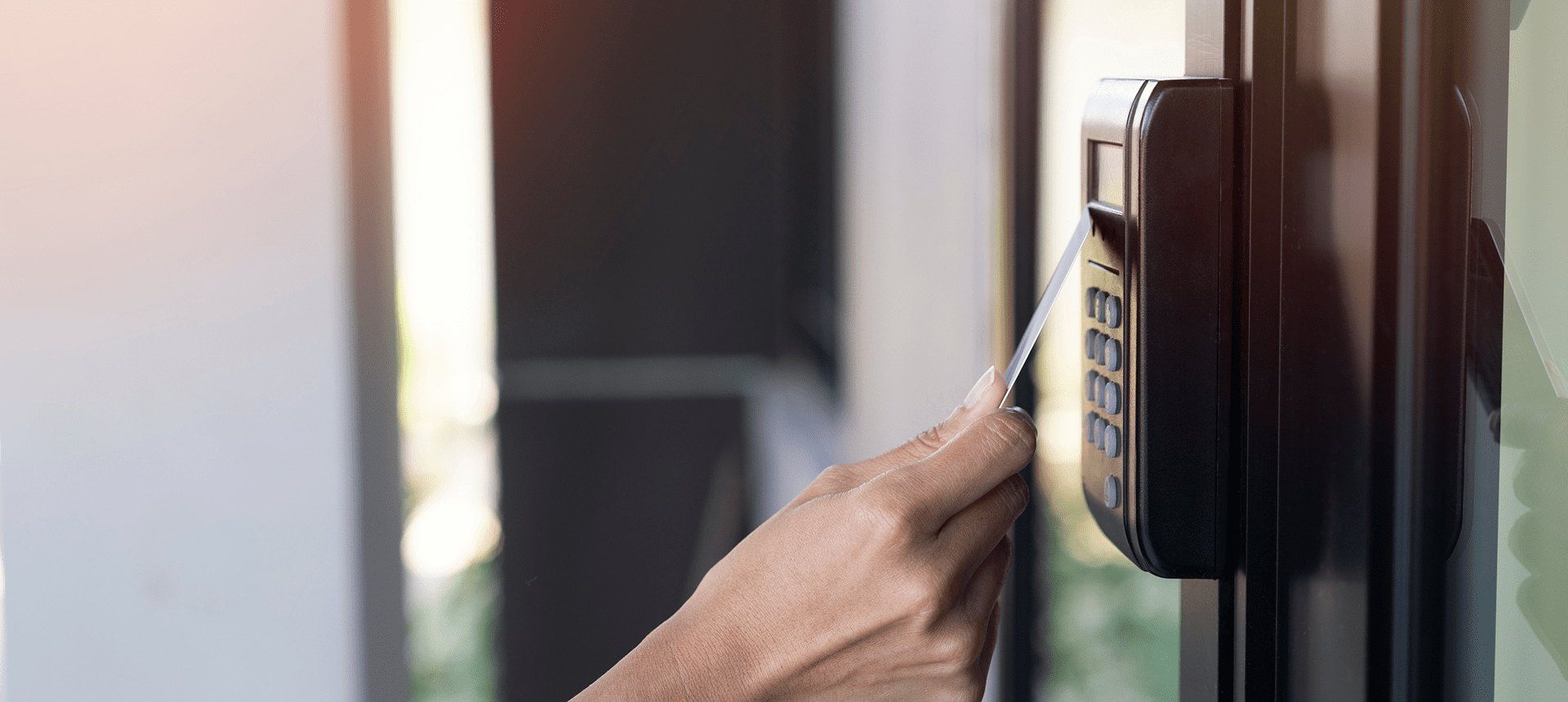 Person swiping card for door access.