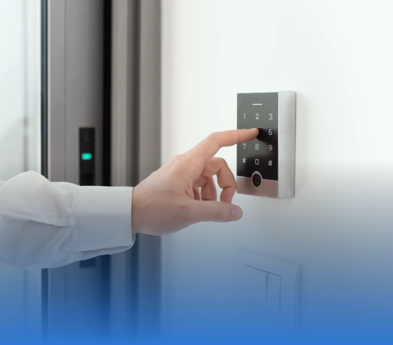 Hand touching digital keypad on wall